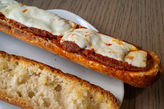 Close up of crusty Almusafes sandwich with sobrasada spread