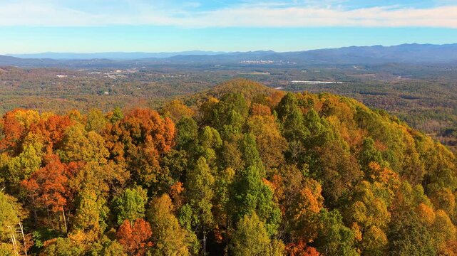 Scenic mountain landscape in North Carolina featuring colorful Appalachian forests during peak autumn. Vibrant foliage covers every hillside.