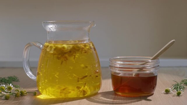 Chamomile Flowers In A Glass Teapot For Brewing Aromatic And Healthy Herbal Tea