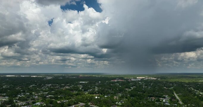 Tropical thunderstorm precipitation falling down on Florida town. Rain shower in summer.
