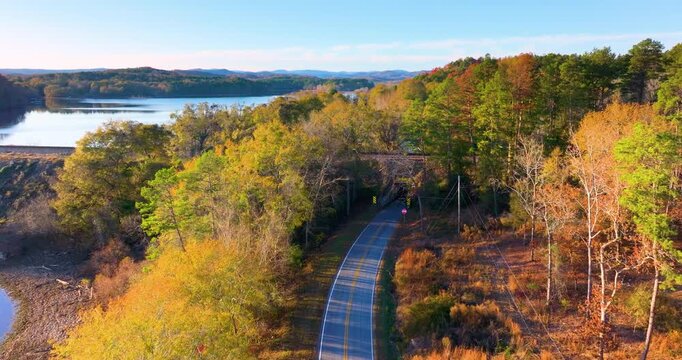 Vibrant autumn landscape in South Carolina mountains. Fall colors stretch across hillsides along quiet mountain road.