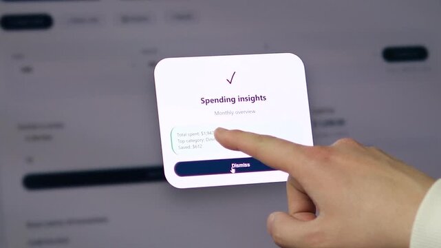 Laptop screen showing a Spending insights popup with a total spent summary and top spending category. User taps to dismiss. 
