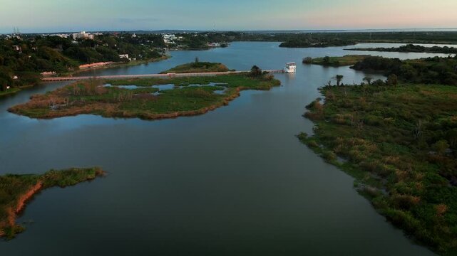 Drone aerial view of Chairel Lagoon at sunset featuring water pumping infrastructure with pipeline systems and park landscape in Tampico
