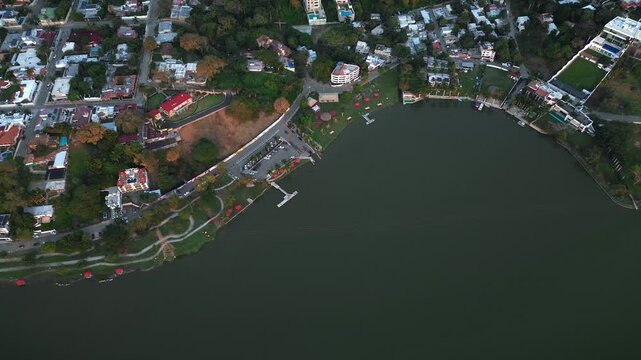 Drone overhead panoramic view of Fray Andres de Olmos park showing verdant gardens calm waterfront and adjacent residential neighborhoods in Tampico
