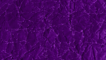 Naklejka premium Abstract purple crumpled paper texture with folds, creases and irregular relief, ideal for artistic backgrounds, grunge designs and creative compositions.