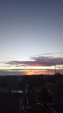 A serene and beautiful sunrise view over the residential cityscape of Depok, West Java, Indonesia, captured from a private rooftop.