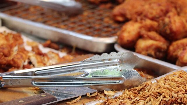 Close-up of a Chef Using a Cleaver to Slice Crispy Fried Chicken Breast