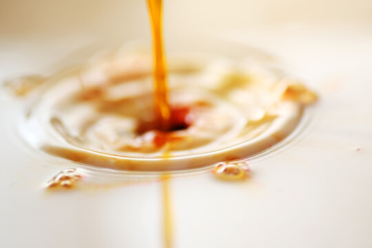 Mixture of caramel syrup into coffee latte