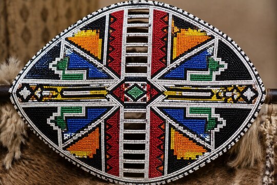 Traditional Zulu shield with vibrant, symmetrical beadwork, cultural artifact.