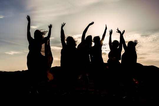 woman in silhouette holding hands