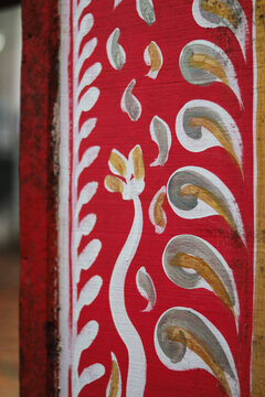 Traditional hand-painted floral motif design on a vintage wooden Palki palanquin.