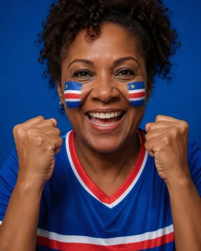 Mature woman wearing a soccer jersey and face paint, celebrating with enthusiasm