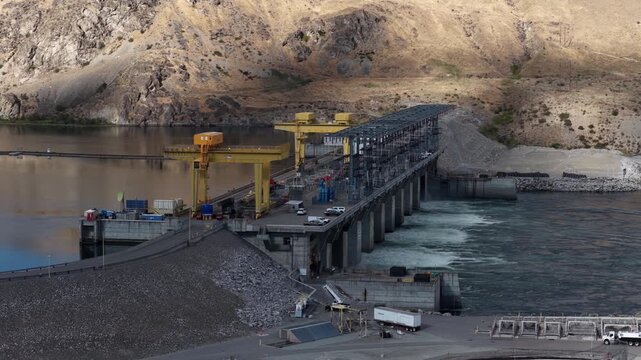 Aerial of Wells Dam construction site on the Columbia River in Azwell Washington in dry rolling hills in summer