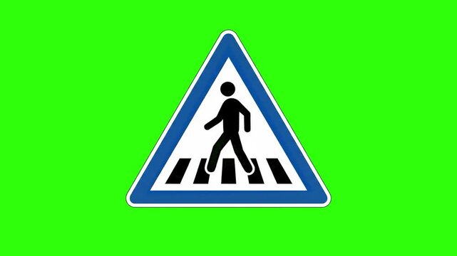 A classic triangular traffic sign featuring a black silhouette of a person walking on a crosswalk, set within a blue and white border. Isolated against a chroma key green screen, this essential traffi
