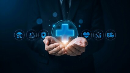 Fototapeta premium Businessman presenting a glowing blue medical cross symbol on his hands with various icons floating around