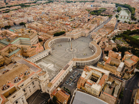 Aerial view of St. Peter's Square with its iconic colonnades, central obelisk, and surrounding historic buildings in Vatican City, Vatican City.