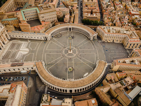Aerial view of St. Peter's Square with its iconic colonnades and central obelisk surrounded by historic buildings in Vatican City, Vatican City.