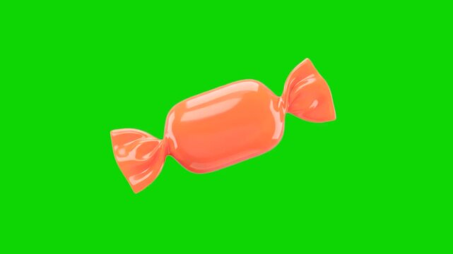 A glossy 3D animated orange wrapped candy or bonbon floating at an angle. Set against a solid chroma key green screen background, this sweet confectionery asset is ideal for holiday, birthday, or tric