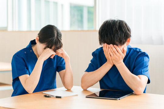 Doctors, nurses, healthcare workers, occupational therapists, and physical therapists (male and female) wearing scrubs (feeling depressed/shocked)