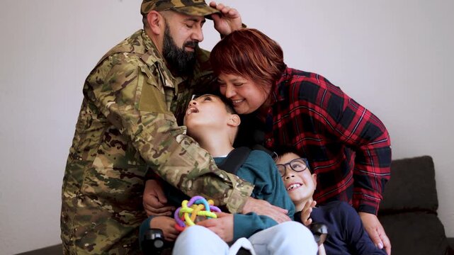 Happy mother, father and son with disability having fun together at home - Family love and support concept