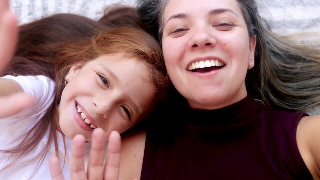 Happy Latin mother and daughter having fun together at home - Family love life concept