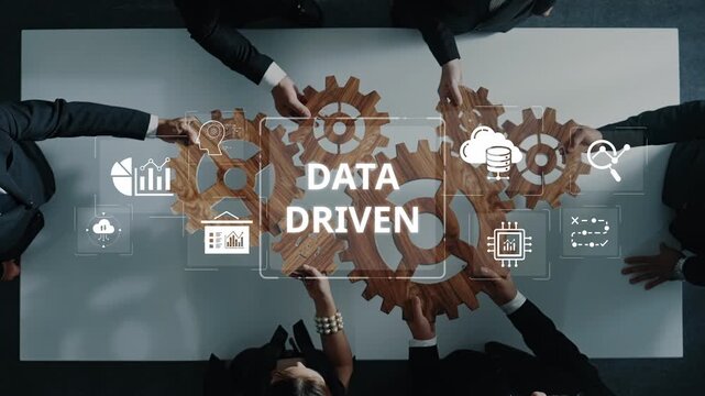 Team members engage in a professional meeting centered on data-driven strategies, analyzing metrics and tools to drive informed decisions for business success. Raster