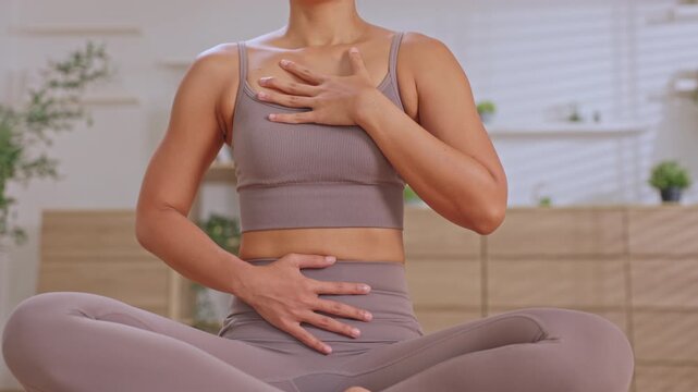 Calm peaceful woman practicing mindful yoga meditation deep breathing at home, feeling relaxed while focusing on physical fitness, mental wellness, pose exercises