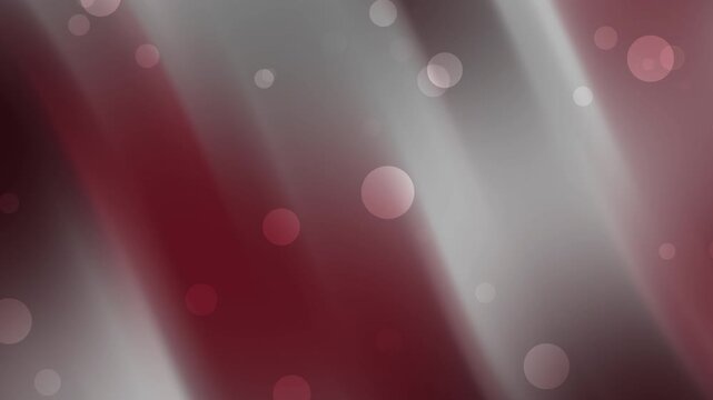 Abstract dark red and gray gradient background waves with soft light bokeh circles create a bright and blurry pattern suitable for backgrounds or textures.