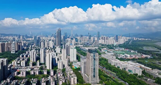 Aerial view of the modern business district with skyscrapers under a blue sky in Shenzhen, China