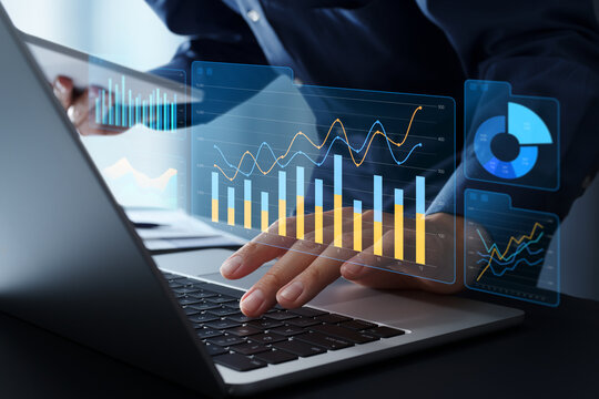 Business data analytics dashboard visualizing real time business insights. Graphs and charts of key performance indicators KPI and financial metrics. Businessman using laptop computer and tablet.