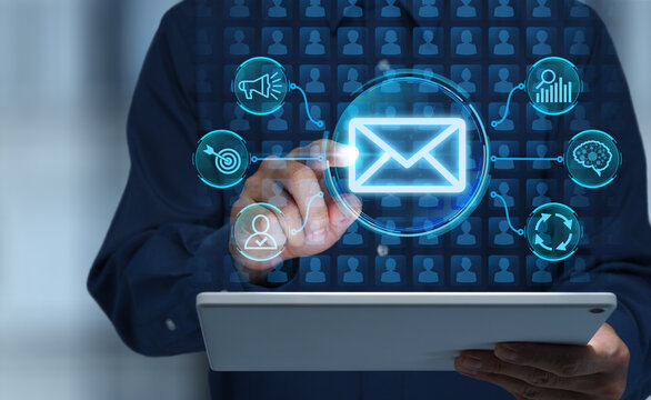 Email marketing technology automating campaign management and performance analysis. Sending personalized messages to target customers based on segmentation analysis. Businessman tapping  tablet.