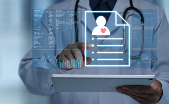 Doctor reviewing electronic health records EHR on digital tablet during medical consultation. Man tapping patient records and data.