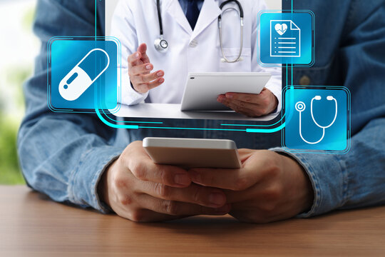 Telemedicine via smartphone app. Patient receiving virtual healthcare. Online doctor consultation. Man using mobile phone at table at home.