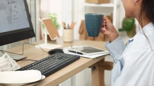 Ecommerce, order, management, online, seller types at computer beside ceramic plates and shipping labels, handling product records and customer orders in home office for smooth daily business workflow