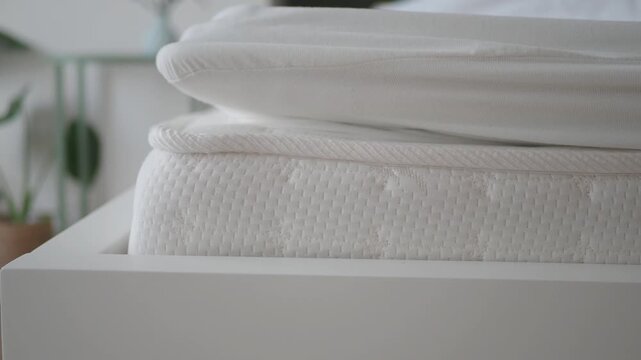 Mattress and bedding preparation in a bedroom setting