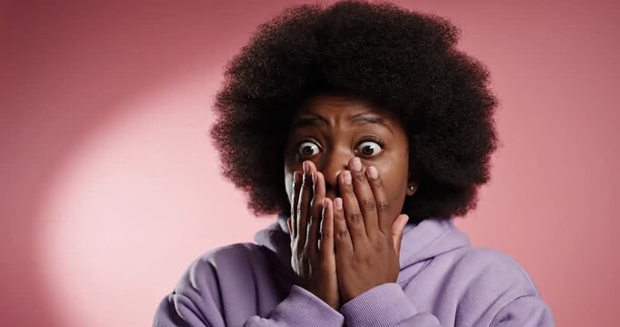 Surprised young man with afro.