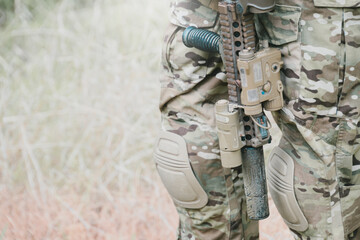Outdoor military concept. Military uniform camouflage uniform soldier weapon rifle tactical gear knee pad outdoor field combat defense armed patrol © JK_kyoto