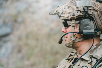 Outdoor military concept. Military soldier in profile wearing helmet headset and sunglasses © JK_kyoto