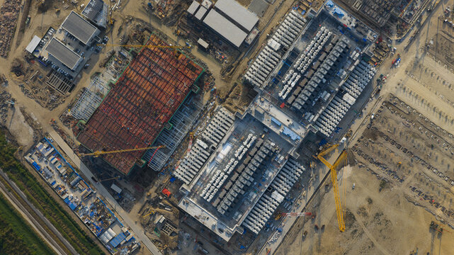 Khlong Tamru, Chon Buri, Thailand - 09 March 2026: Aerial view of Bridge Data Center under construction with large industrial structures, cranes, and site infrastructure.