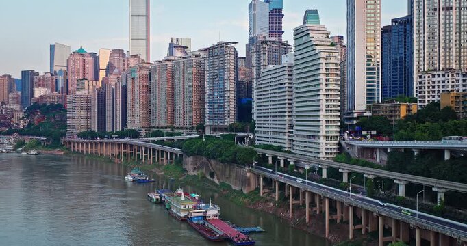 High-density residential buildings and river traffic at sunrise in Chongqing, China