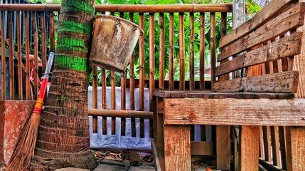 Rustic Wooden Bench Under Coconut Tree in Traditional Indonesian Village  © Andi