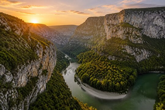 Aerial view of lush green river winding through limestone gorge in France.
