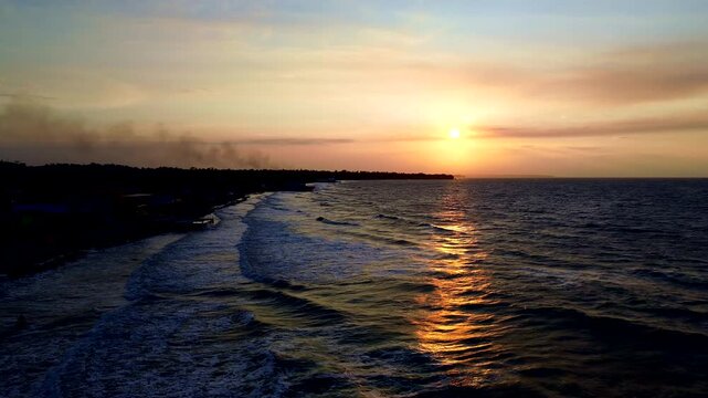 Golden Sunset Over Ecuador Coastline with Breaking Ocean Waves, Dark Shoreline, Sun Reflection and Scenic Tropical South American Seascape