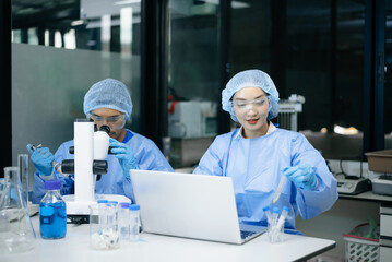 Naklejka premium Multigenerational scientists performing biotechnology and medical research with microscope, laboratory equipment and laptop, showcasing innovation, teamwork