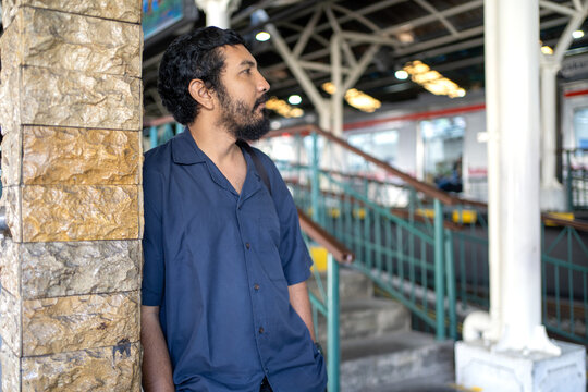 Indonesian Commuter Waiting at KRL Train Station Platform