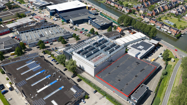 Diemen, Netherlands - 05 June 2026: Aerial view of Switch Datacenters AMS4 surrounded by industrial buildings, warehouses, and a canal in the Netherlands.