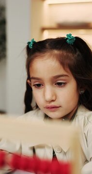 Learning, growth and girl in home with abacus, math practice or fun activity in literacy skills. Education, numeracy or child with calculation, bead counting or number play for cognitive development.