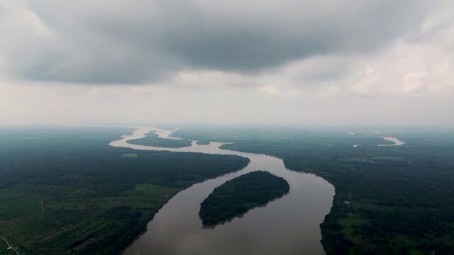 Aerial View of Meandering Amazon River Under Storm Clouds in Ecuador, Rainforest Islands, Brown Water and Dramatic Tropical Landscape