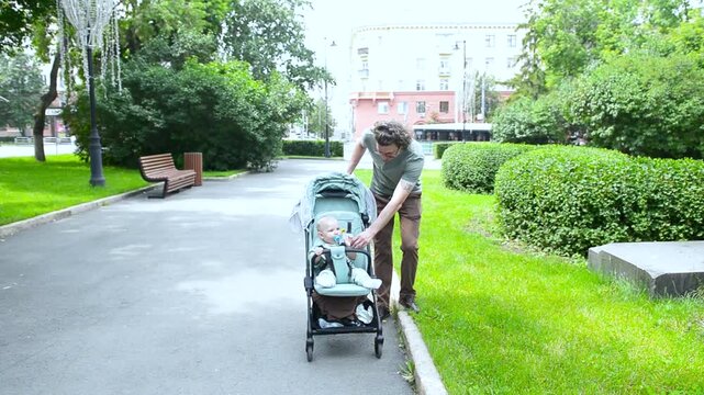 Captured on a beautiful day, a father walks with his one-year-old son in a stroller, enjoying the sights and sounds of nature. The child watches the world go by, filled with wonder and excitement duri