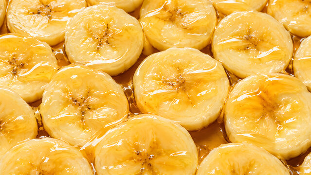 Full Frame of Juicy Banana Slices with honey Close Up